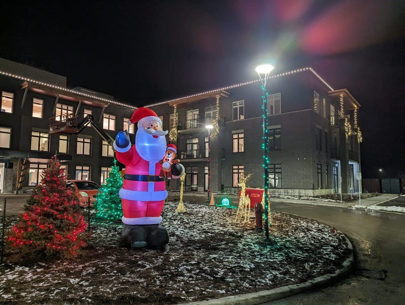 Casinos: Commercial building holiday light display with a giant inflatable Santa, lit trees and reindeer