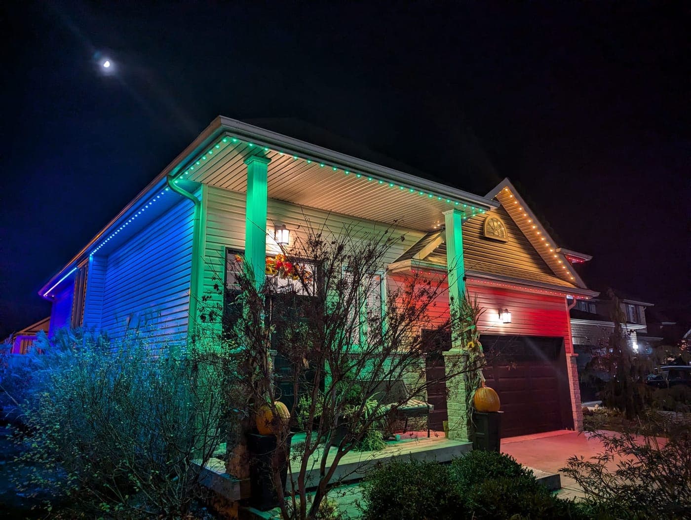 Home washed in blue, green and red multicolour RGB permanent LED roofline lighting