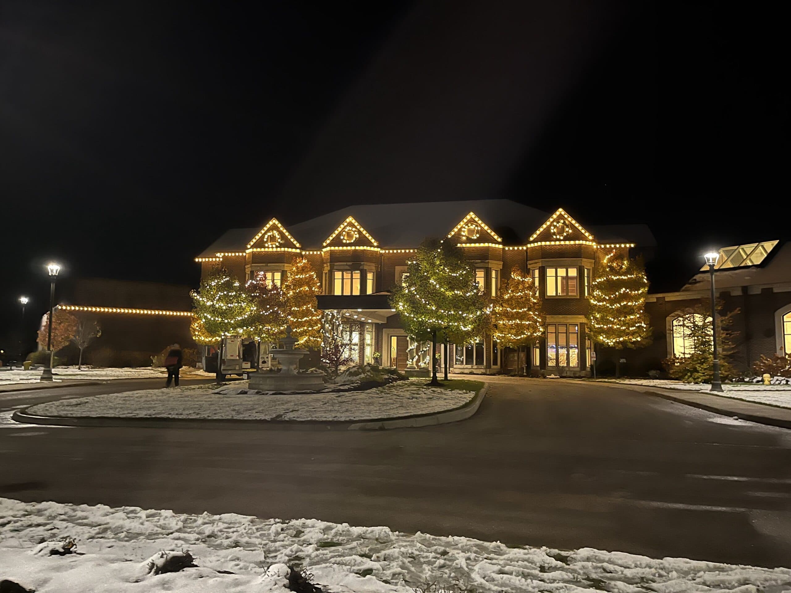 Professional crew installing Christmas lights on a London Ontario home